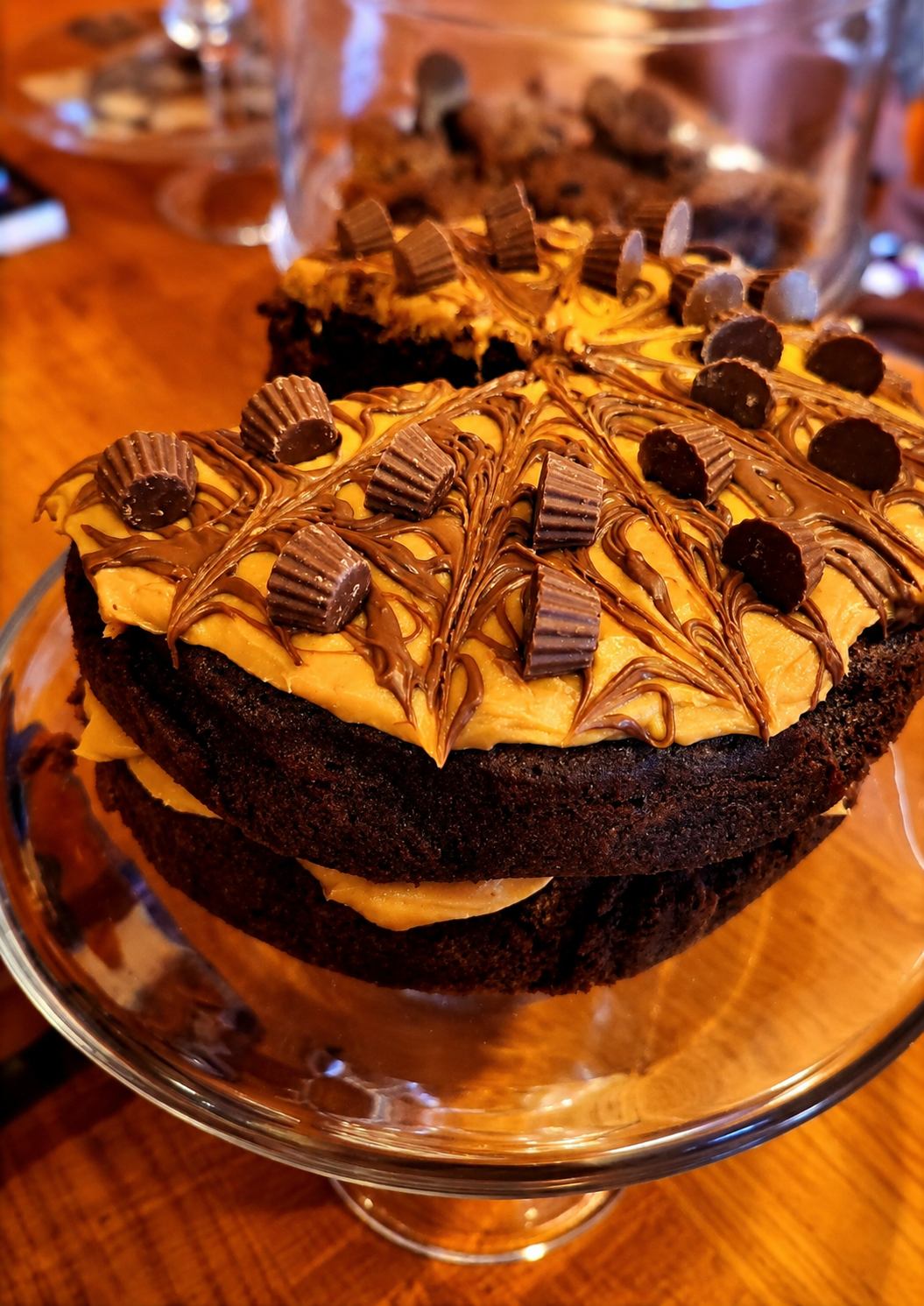 Chocolate and peanut butter cake on a glass stand