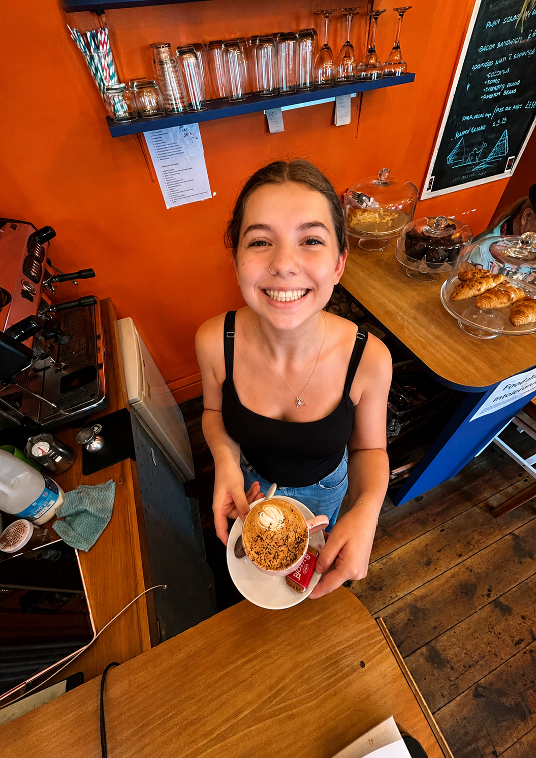 Café team member serving a coffee